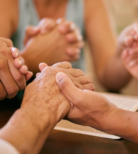 Shot of a group of people holding hands in prayer Shot of a group of people holding hands in prayer